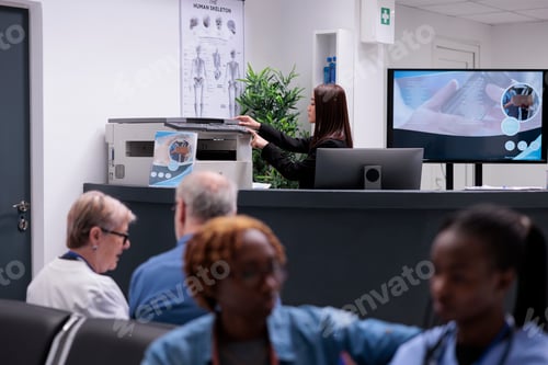Preview: Asian receptionist working with copy printer