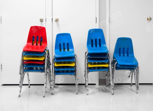 Preview: Four piles of stacked plastic chairs.