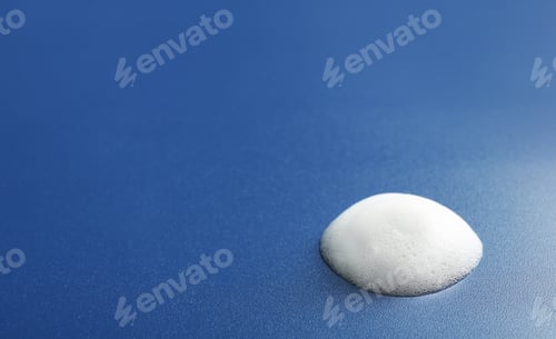 Preview: Drop of soap foam on color background. Space for text