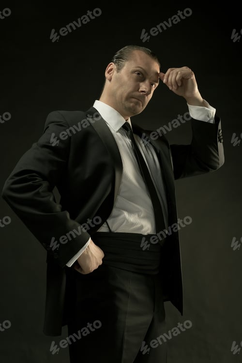 Preview: The Attractive Man In Black Suit On Dark Background