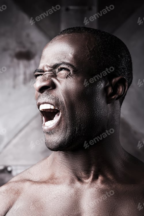 Preview: Furious man. Portrait of furious young shirtless African man shouting and looking away