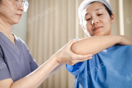 Preview: Physical therapy, professional providing physical therapy assists patient in clinical setting