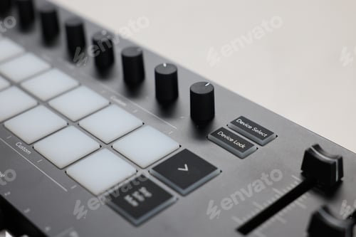 Preview: MIDI keyboard with faders on white table, closeup