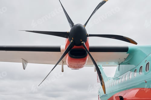 Preview: Retro style. Turboprop aircraft parked on the runway at daytime
