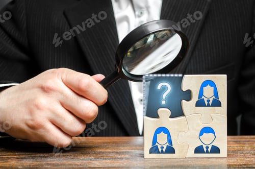 Preview: Businessman with a magnifying glass examines the missing part of the puzzle team