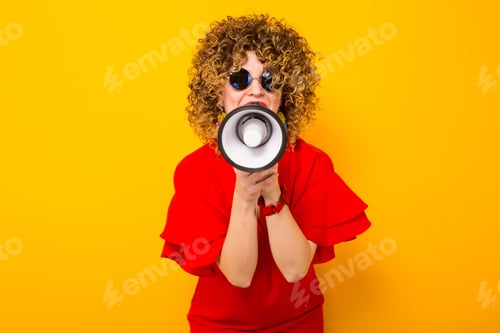 Preview: Attractive woman with curly hair with loudspeaker