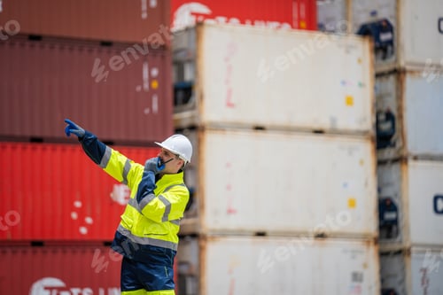 Preview: Engineer or foreman checking inventory or job details with cargo container background.