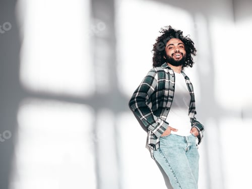 Preview: Handsome smiling hipster man posing in studio