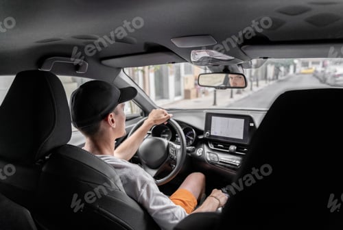 Preview: A young guy driving a car.
