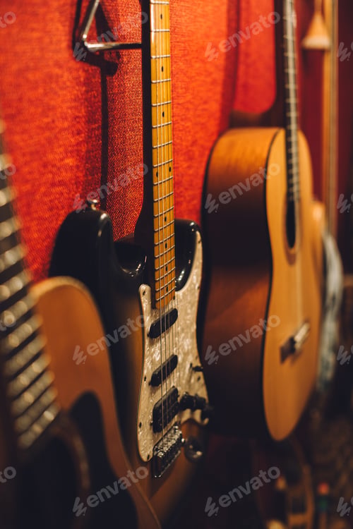 Preview: Electric, acoustic, and bass guitars in a music studio.