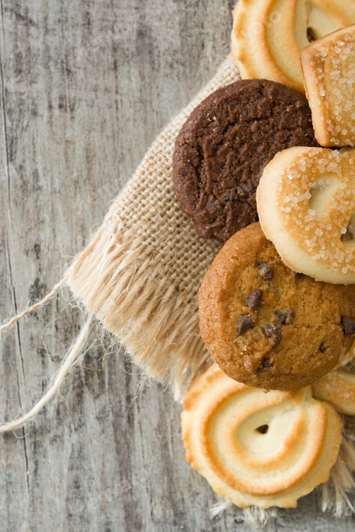 Preview: Delicious assorted cookies lying on rustic wooden table with burlap