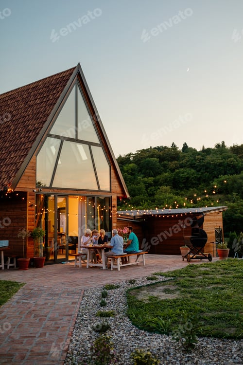 Preview: Three generations family during dinner, celebrating holiday together in the backyard