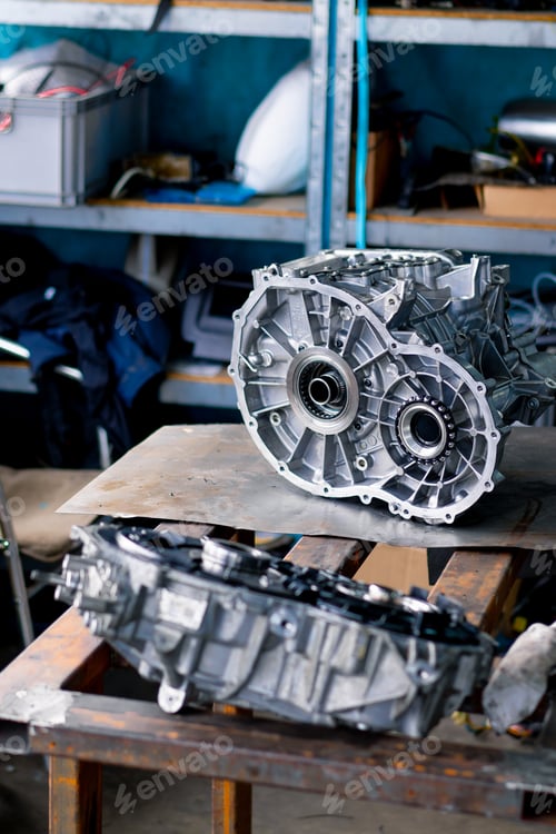 Preview: Close-up of parts of a clean engine block removed from a car for repair which lie on a table