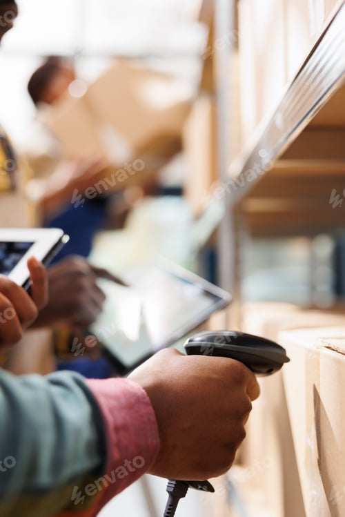 Preview: African american distribution warehouse worker arm scanning box code