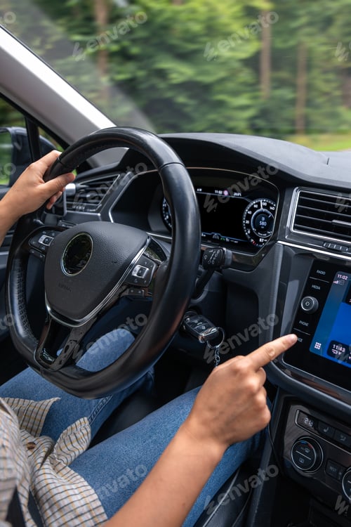 Preview: Female driver with technology. Touch control in car. Travel lifestyle