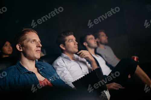 Preview: Young friends watching movie in cinema hall