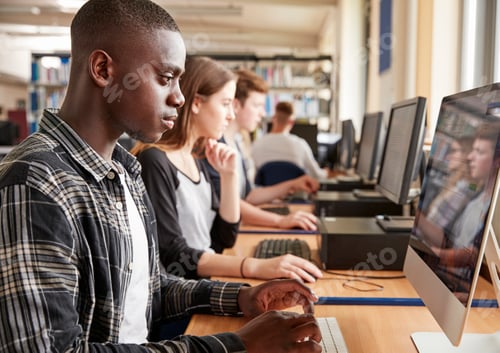 Preview: Group Of Students Using Computers In College Library