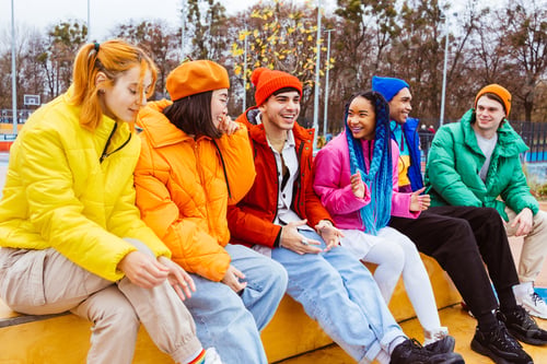 Preview: Multiracial group of young friends meeting outdoors in winter