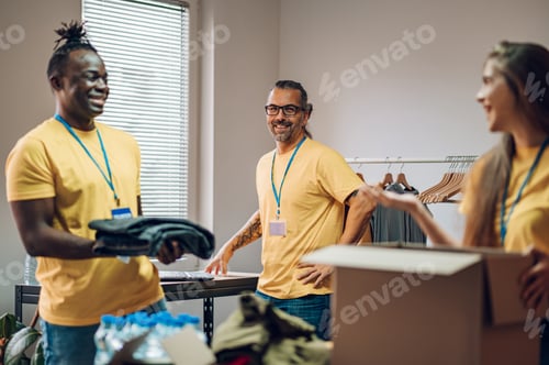 Preview: Group of multiracial volunteers working in community charity donation center