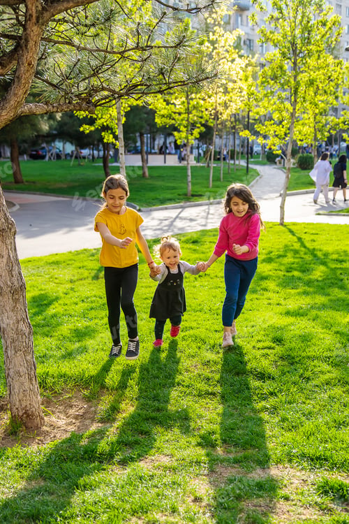 Preview: Children walk together in a friend's folder. Selective focus.