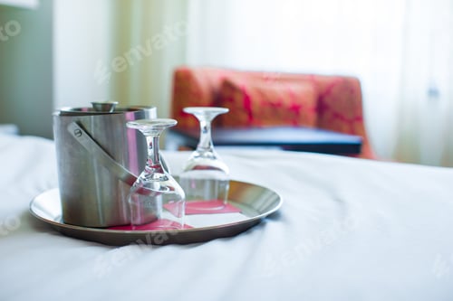 Preview: Romantic bedroom with wine glasses and ice bucket in luxury hotel interior