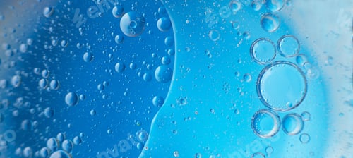 Preview: abstract light blue background with oil circles . bubbles of water close up .