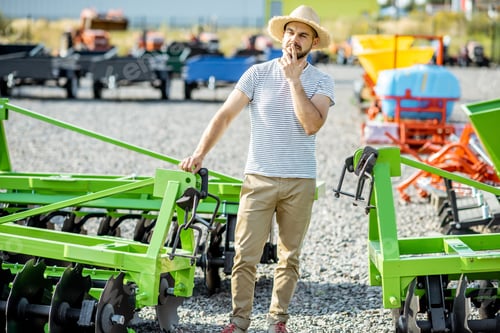 Preview: Agronomist at the shop ground with agricultural machinery