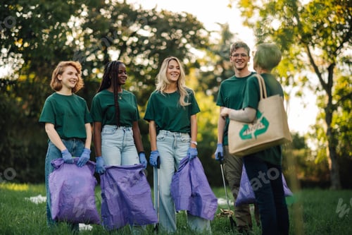 Preview: Group of people volunteers collecting rubbish in park