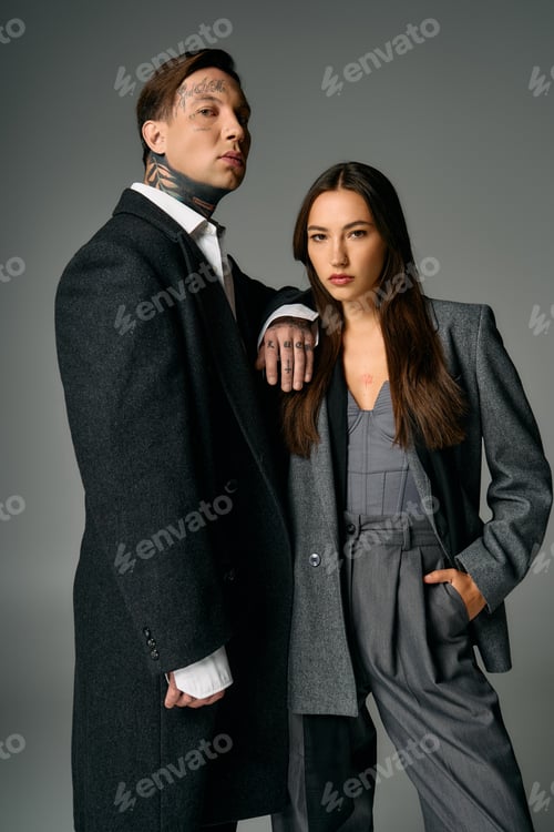 Preview: Young attractive couple posing elegantly in stylish outfits in a modern studio setting