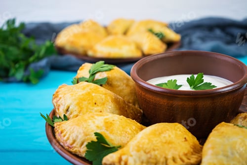 Preview: Delicious baked empanadas on wooden background