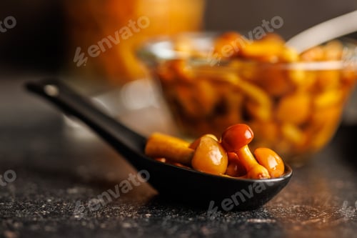 Preview: Pickled nameko mushrooms.Traditional japanese mushrooms in spoon on black table.