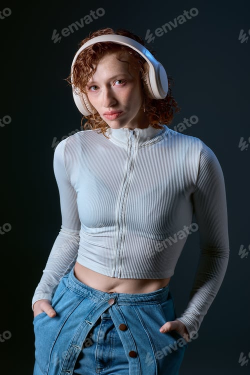 Preview: Curly haired young woman immersed in music while relaxed in a studio setting