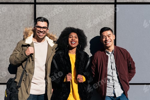 Preview: Portrait of group of friends looking the camera in the street.