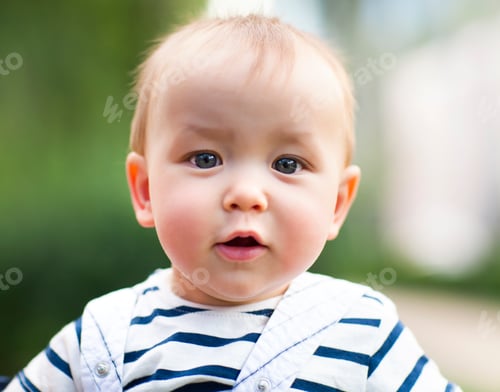 Preview: Close up portrait of the smiling baby boy outdoors