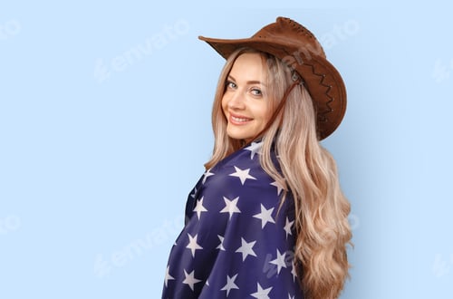 Preview: Portrait of a young woman holding USA flag isolated on color background