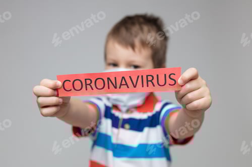 Young child wearing a respiratory mask as a prevention against the Coronavirus Covid-19
