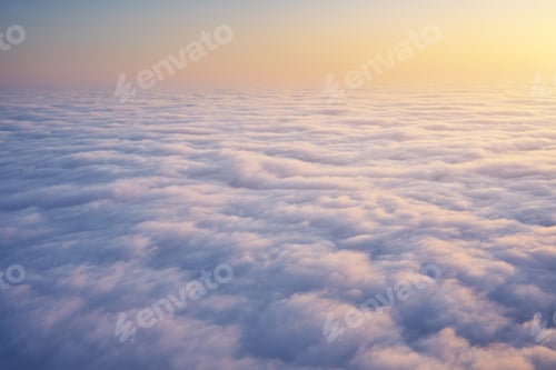 Preview: Aerial view on white clouds and clear sky during the sunset.