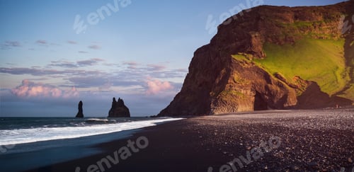 Preview: Famous Reynisdrangar rock formations at black Reynisfjara Beach. Coast of the Atlantic ocean near