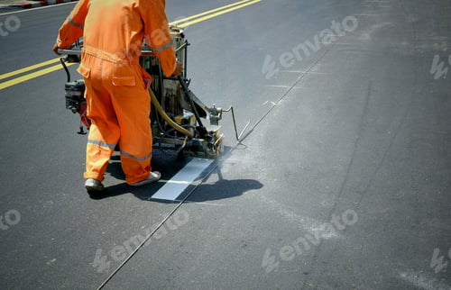 Preview: road worker using thermoplastic spray road marking machine to painting white line on asphalt street