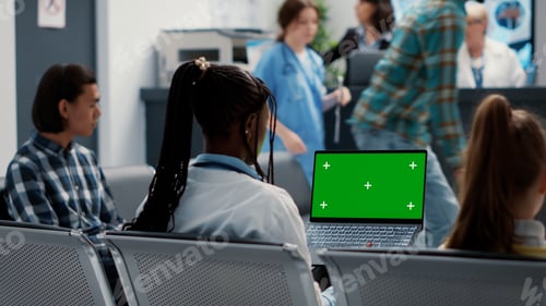 Preview: African american physician working with greenscreen on laptop