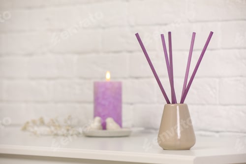 Preview: Reed air freshener with essential oil on table indoors. Space for text