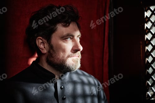 Preview: Middle Aged Man Reflecting Inside Church Confessional Booth