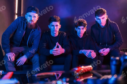 Preview: Group of people is together in the studio with futuristic neon lighting