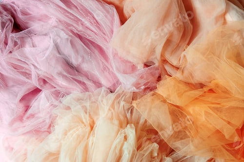 Preview: Top view abstract background of crumpled peach and pink chiffon.