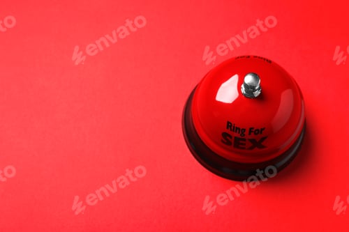 Preview: Sex bell on red background, above view. Space for text