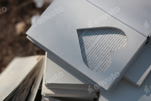 Preview: On old books, a frame in the shape of a heart is cut out. Place for rings. Wedding concepts