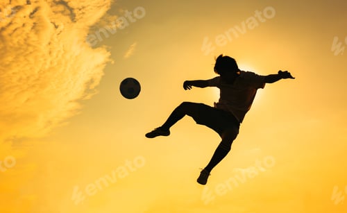 Preview: Silhouette action sport outdoors of football players on the sunset sky. Athlete man jumping kick soc