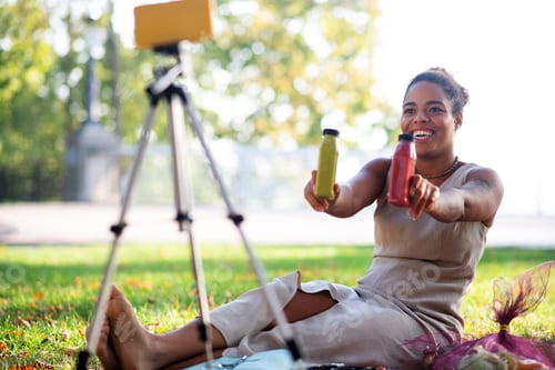 Preview: Woman showing her favorite smoothies while filming video