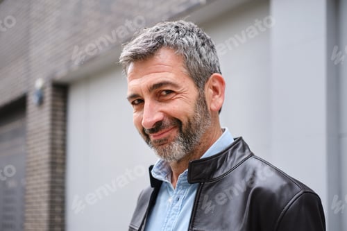 Preview: Confident man smiling looking at camera outdoors