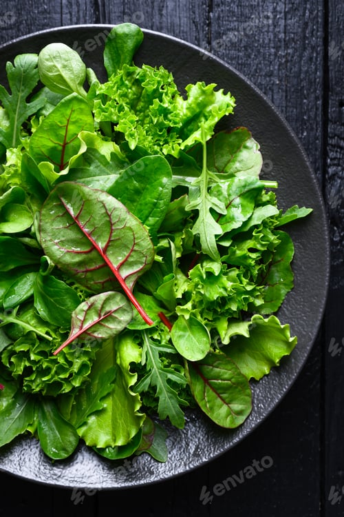 Preview: Fresh mix salad leaves arranged on black plate